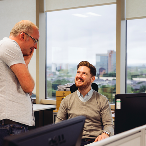 two men speaking a smiling