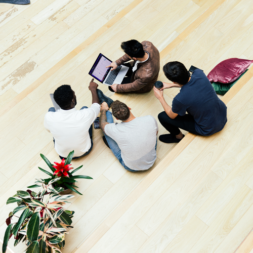 four people working together