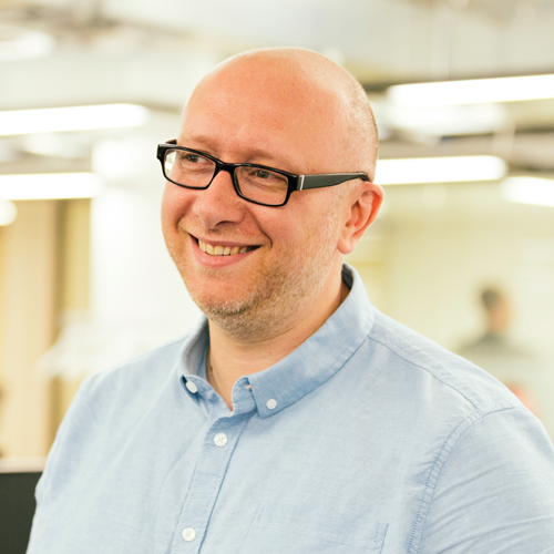 man with glasses smiling