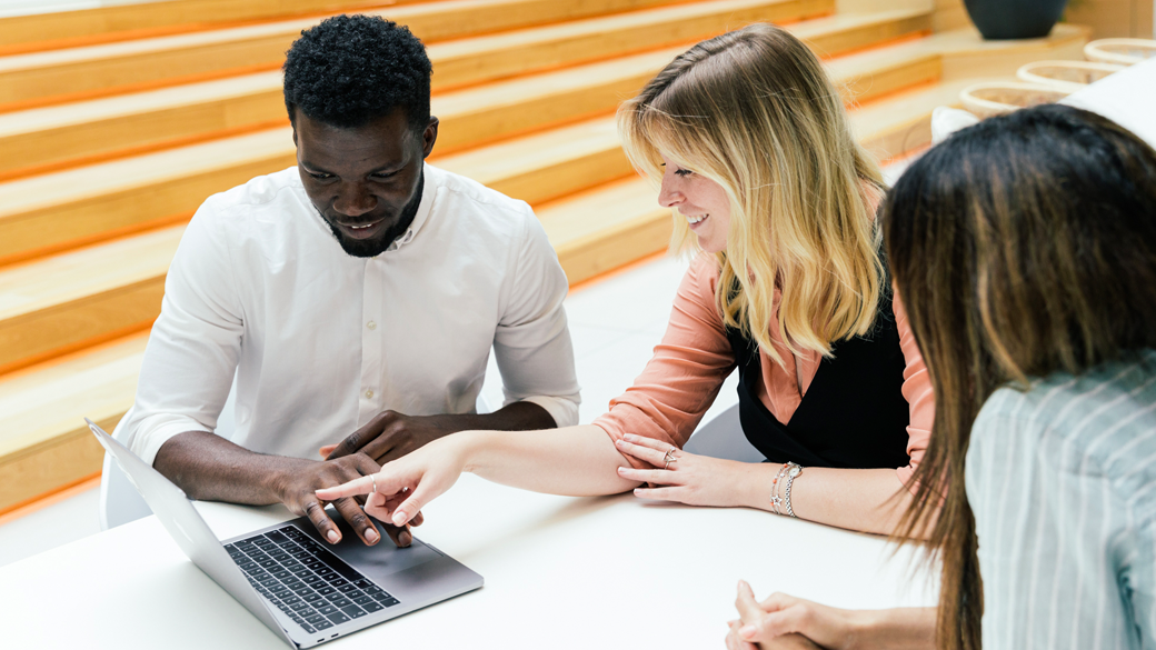 three people working together