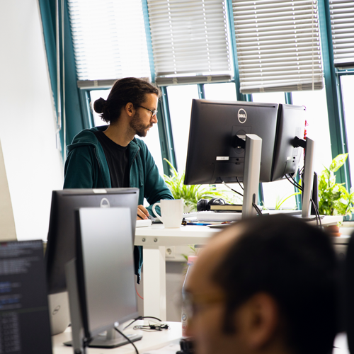 man working at standing desk