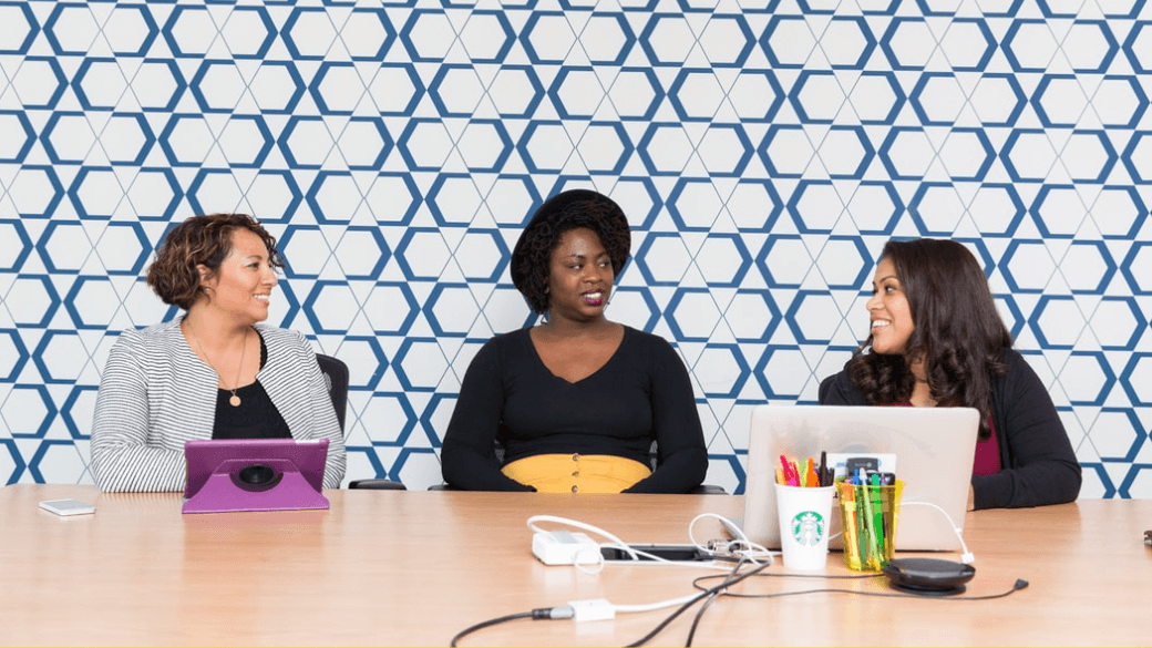 three women in a meeting