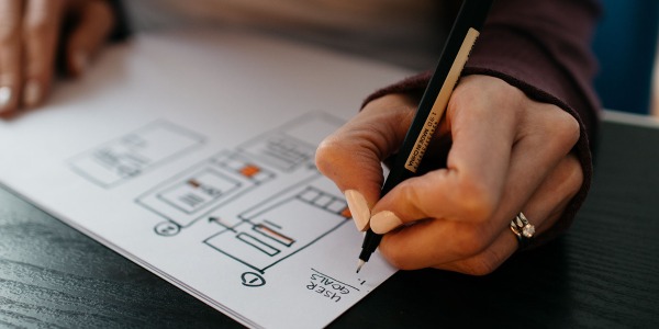 Cutover image, artist drawing a wireframe for an app