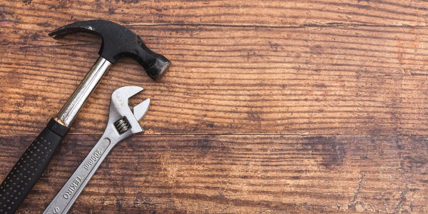 Homeserve image, hammer and spanner on a wooden background